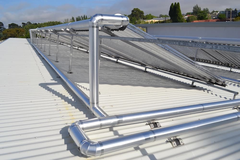 Silver pipe cladding installed on a rooftop