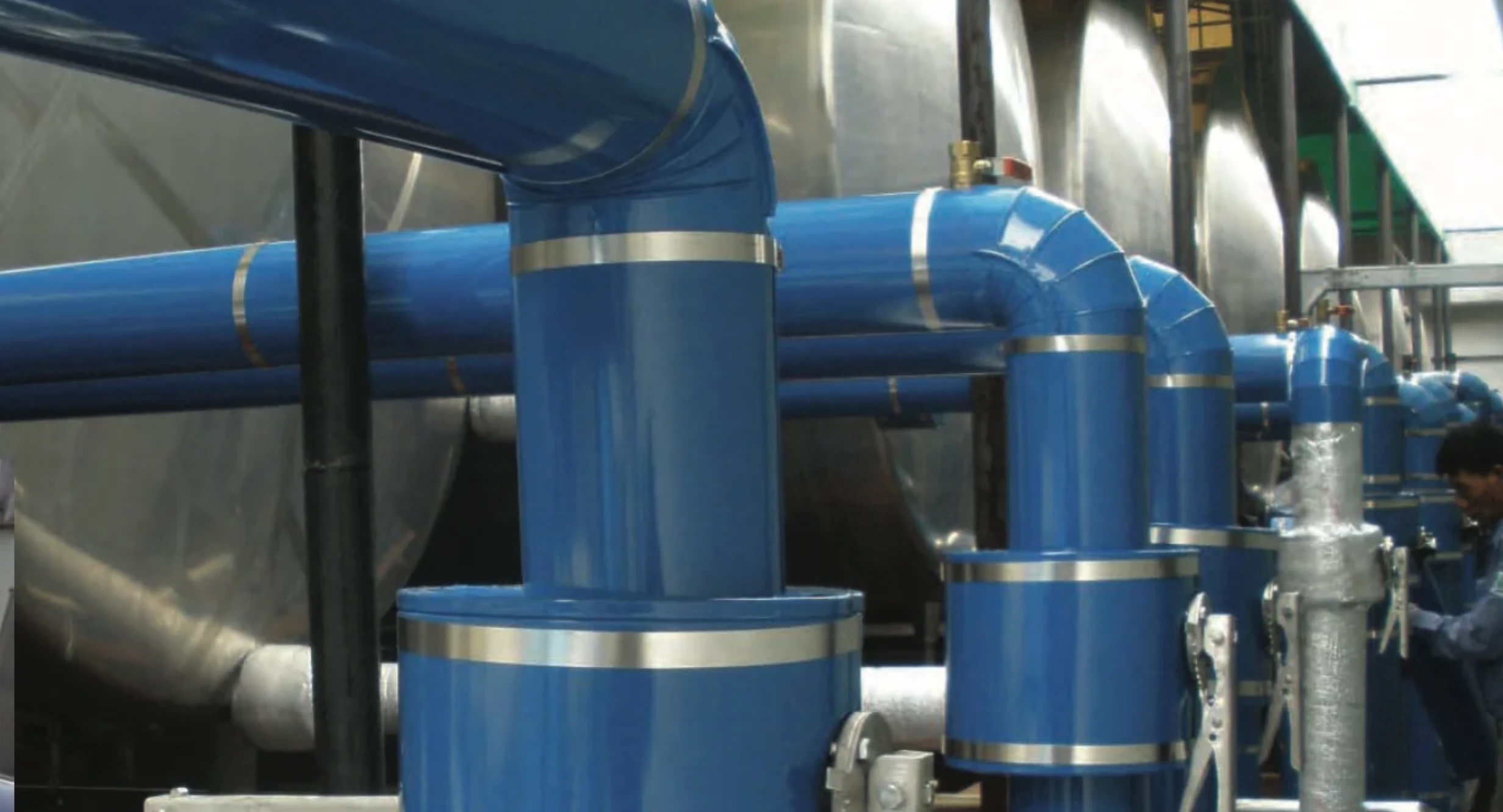 Blue ClickClad Elbow Covers installed on industrial pipework