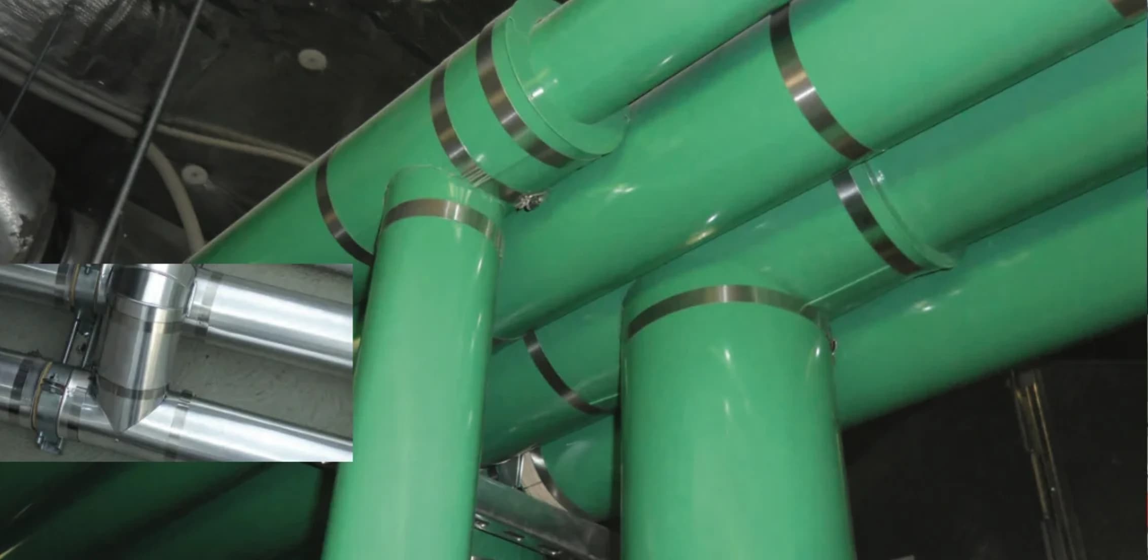 Green ClickClad Tee Covers installed across parallel pipe runs